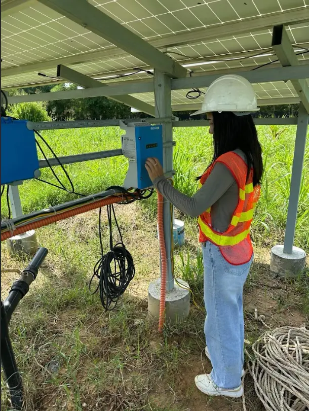 KB Engineering staff checking the control box for solar panels installed at Baby Bird Farm.